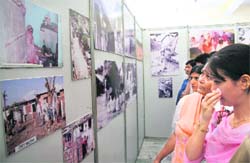 A girl wipes her tears while looking at photos of Kashmiri Pandits killed at the time of migration in the Valley in Jammu