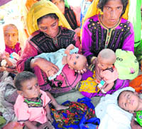 Women and children in a newly established camp on September 5, 2010
