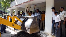 Agitators dump stone chips in front of the office of the Assistant Divisional Engineer, Northern Railway, Bathinda, on Monday. They were protesting against delay in repair of roads.
