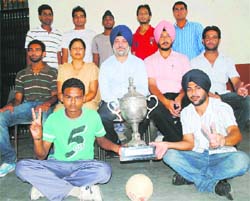The winning team of Punjabi University Inter-College Handball Championship after receiving the trophy at Khalsa College in Patiala on Monday. A Tribune photograph
