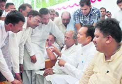 Naveen Jindal, MP, accompanied by Tajinder Mann, DCC president, hears public grievances at a village in Kaithal district.