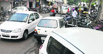Haphazardly parked vehicles outside Krishna Hospital give a tough time to commuters.