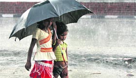 A girl and her brother share an umbrella as rain lashed Ludhiana on Monday.