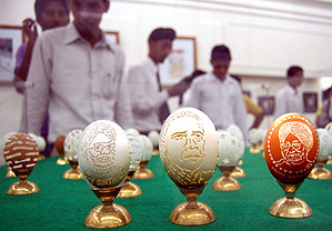 Schoolchildren view images carved on egg shells by artist Harvinder Singh Gill during a two-day exhibition at the Art Gallery in Amritsar.