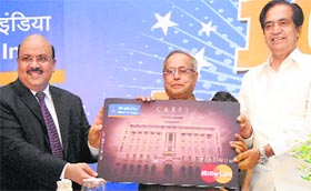 Finance Minister Pranab Mukherjee flanked by Namo Narain Meena (R), Minister of State for Finance, and Alok K. Misra (L), CMD, Bank of India, at the launch of Platinum card on the 105th foundation day of the bank, in New Delhi on Tuesday.