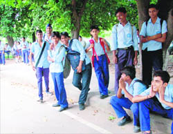 Schoolchildren share a laugh while waiting for buses, which never came due to the national-level strike by various trade unions in Chandigarh on Tuesday.