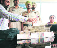 Excise officals count Hawala money seized at Phase I, Mohali, on Monday night.