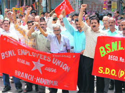 BSNL employees raise slogans at Gandhi Chowk in Hamirpur on Tuesday. 