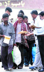 Indian officials scrutinise documents of fishermen who were released by the Pakistan Government at the Attari-Wagah joint check post on Tuesday