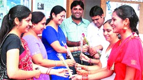 Students greet teachers with flowers during Teachers Day celebrations at the Apeejay College of Fine Arts in Jalandhar.