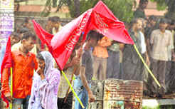 Protesting trade union activists caught in a sudden shower.