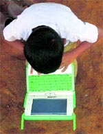 A school boy uses a laptop provided under the One Laptop Per Child project by an NGO on the eve of International Literacy Day at Khairat village, 90 km from Mumbai, on Tuesday.