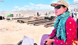 Chandra, a Russian girl who is member of an NGO, supervises construction work at the Solar Valley relief camp in Choglamsar, Leh, on Tuesday.