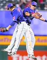 Cleveland Indians Trevor Crowe (L) leaps in the air to meet centrefielder Michael Brantley to celebrate beating the Los Angeles Angels during their MLB American League baseball game in Anaheim, California, on Monday