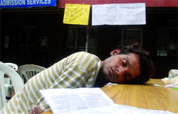 A patient waits outside the Safdarjung Hospital in New Delhi on Wednesday