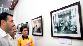 Onlookers catch a glimpse of photographs during an exhibition at the Viceregal heritage complex in Shimla on Wednesday