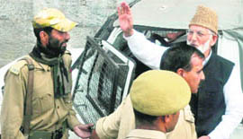 Chairman of the hardline faction of the Hurriyat Conference Syed Ali Shah Geelani waves to his supporters before being taken into preventive custody in Srinagar on Wednesday.