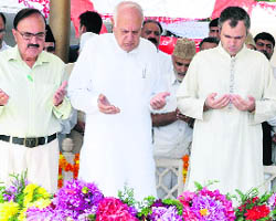 Chief Minister Omar Abdullah, Union Minister for New and Renewable Energy Farooq Abdullah and other leaders of the NC offer prayers at the grave of Sheikh Abdullah on his death anniversary in Srinagar on Wednesday.