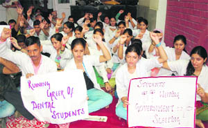 Students of Indira Gandhi Government Dental College protest against the derecognition of their batch by the Dental Council of India in Jammu on Wednesday.