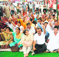 Activists of the BJP stage a protest at Gole Market at Gandhi Nagar in Jammu on Wedneday.