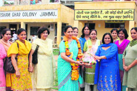 Staff members of Government Girls High School, Jammu, felicitate  Shreshtha Sharma for getting the Best Teacher Award on Wednesday.