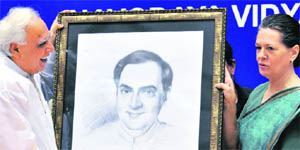 HRD Minister Kapil Sibal presents a portrait of ex-PM Rajiv Gandhi to Sonia Gandhi in New Delhi.