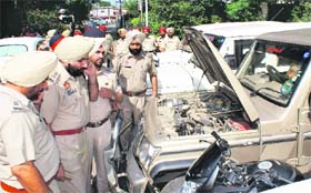 BIG BOOTY: Cops inspect the stolen vehicles recovered from the gang at a rest house in Rajpura
