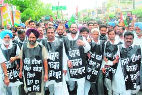 Congress workers led by MLA Harminder Singh Jassi stage a protest against the state government for selling public property in Bathinda