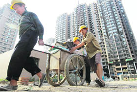 Workers move construction material at a construction site in Beijing on Thursday. Some Chinese cities are preparing fresh property tightening steps as housing transactions and prices show signs of a rebound, reinforcing market expectations that Beijing will not ease its grip on the sector any time soon
