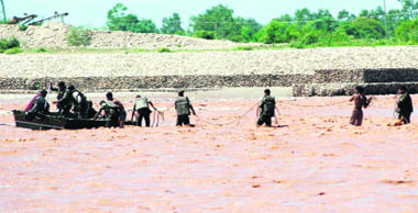 Army personnel rescue a man trapped in the Tawi river