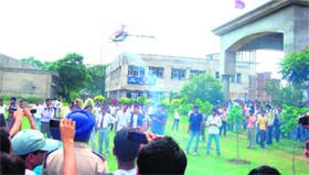 Students look on as a model helicopter takes off during an air show at RIMT Engineering College, Mandi Gobindgarh