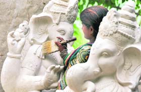 An artist gives final touches to an idol ahead of Ganesh Chaturthi in Ludhiana