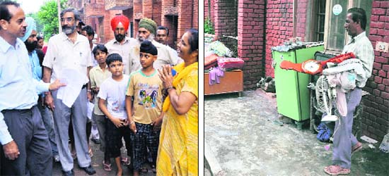 A woman pleads with an official to let her stay even as an MC employee (right) dumps household articles outside a house in the Dugri area of Ludhiana