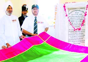 Col GS Sidhu (wearing a cap) offers a chadar at the tomb of Havildar Abdul Hamid, winner of the Param Vir Chakra, in Asal Uttar village