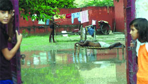 A man sleeping in his waterlogged house near the flood-hit Usmanpur in New Delhi on Friday.