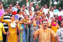 Workers of Uttarakhand Kranti Dal hold a torch rally in Dehradun on Friday. 