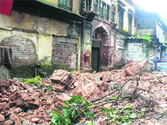 A part of an old dilapidated building collapse in Dehradun on Thursday night. 