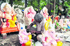 An artiste prepares Lord Ganesha idols on the eve of Ganesh Chaturthi in Dehradun on Friday.