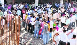 A crowd gathers at the AC market where shopkeepers clashed over the demolition of shops in Ludhiana on Friday.
