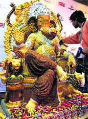 An artiste gives final touches to the idol of Lord Ganesh made of biscuits and chocolates ahead of Ganesh Chaturthi celebrations, in Mumbai on Friday. 
