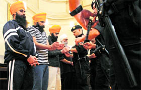 Defendants stand in a courtroom before the start of their second trial in Vienna on Friday. Five men went on trial for several charges including murder and attempted murder on Friday, following a gun and knife attack on a gathering at a gurdwara in Vienna on May 24, 2009.
