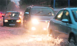 Vehicles move on a waterlogged road in Chandigarh on Saturday.