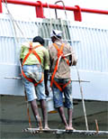 Workers paint a bridge near Indira Gandhi Stadium ahead of the Commonwealth Games in New Delhi 