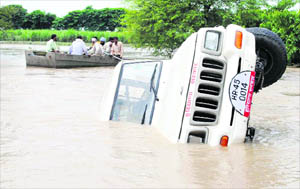 The jeep that was caught in the flood waters at Nagli village in Karnal district.