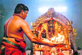 A priest pays obeisance to Lord Ganesha on the first day of the Ganesh Chaturthi festival at the Sankat Mochan temple in Shimla