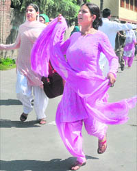 Women run for cover after the police fired into the air in Srinagar on Saturday.