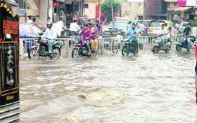 A few minutes of showers left a road flooded causing inconvenience to commuters in Ludhiana
