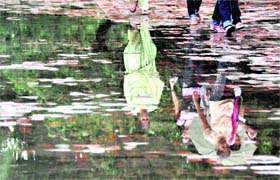 A reflection shows images of students