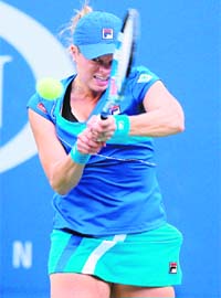 Kim Clijsters of Belgium returns a shot against Venus Williams of the US during women's semifinal match of the US Open in New York