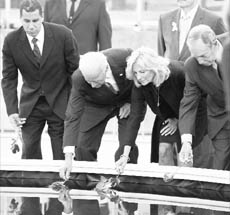 US Vice-President Joe Biden (2nd L) and his wife Dr Jill Biden (2nd R), with New York Governor David Paterson (L) and New York City Mayor Michael Bloomberg place flowers at the reflecting pool at the World Trade Center site on Saturday.